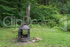 Stove and firewood in the yard on the grass