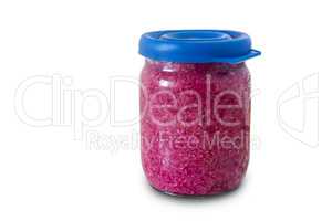 Jar with grated horseradish on a white background.