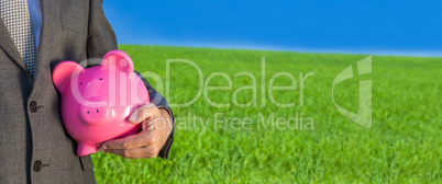 Panoramic Man Businessman Holding Piggy Bank in Field Banner