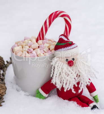 gray ceramic cup with hot chocolate, marshmallow and candy