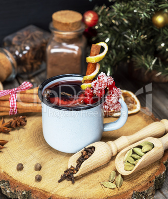 mulled wine with spices in a blue iron mug