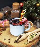 mulled wine with spices in a blue iron mug