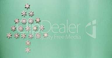 Wooden Snowflakes Building A Christmas Tree, Green Paper Background