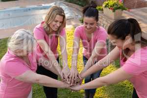 Women joining hands for breast cancer awareness