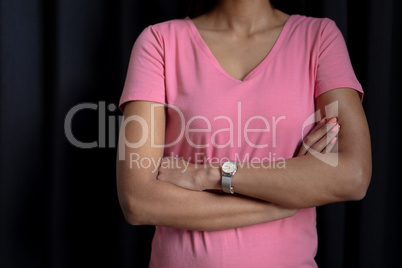 women in pink for breast cancer focus on crossed arms
