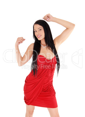 Happy woman dancing in a red dress and black hair