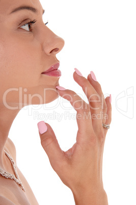 Gorgeous face of a young woman, finger on chin