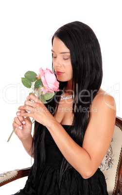 Woman sitting in armchair smiling pink roses