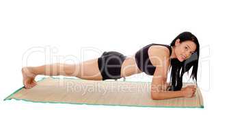Woman lying on mat doing push ups