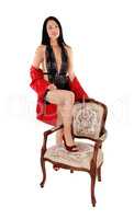 Pretty woman standing in lingerie with old chair