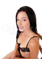 Close up image of woman wearing a black bra