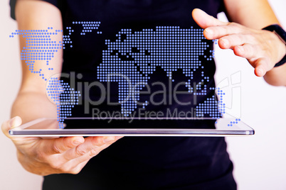 Woman holding tablet computer with world map