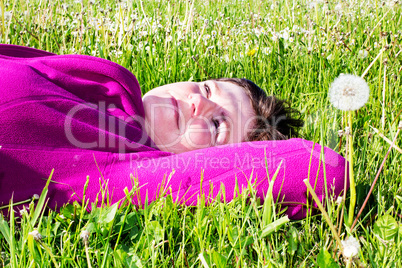 Woman lying on the lawn in the grass