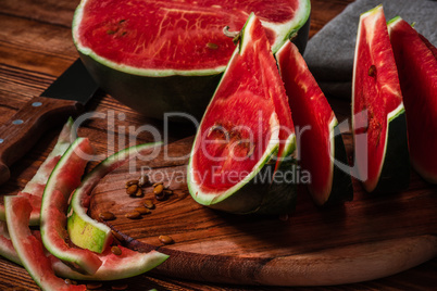 Watermelon slices and peels lying on cutting board