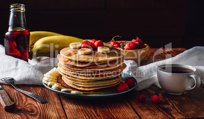 Pancakes with Fruits, Maple Syrup and Cup of Tea.