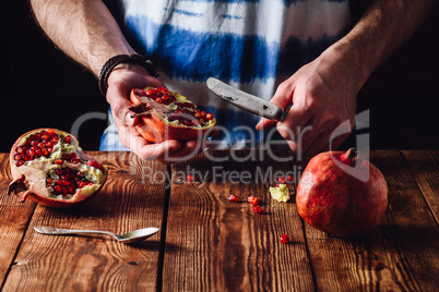 Pomegranate and Knife in Human Hands.