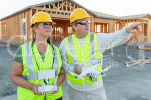Workers with Drone Quadcopter Inspecting Photographs on Controller