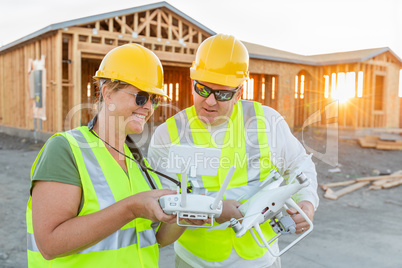 Workers with Drone Quadcopter Inspecting Photographs on Controller