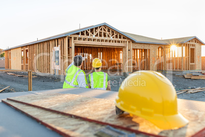 Male and Female Construction Workers at New Home Site