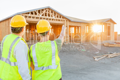 Male and Female Construction Workers at New Home Site