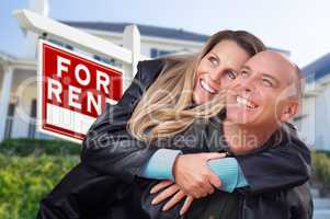 Happy Couple Hugging in Front of For Rent Real Estate Sign and H