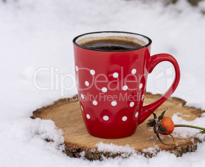 red mug in a white dot with hot black coffee