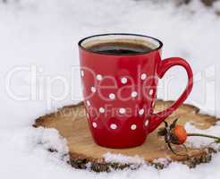 red mug in a white dot with hot black coffee