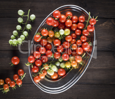 ripe red cherry tomatoes in an iron