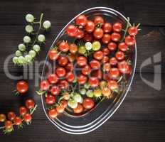 ripe red cherry tomatoes in an iron