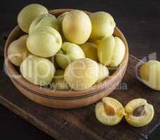 ripe apricot varieties of pineapple in a brown wooden plate
