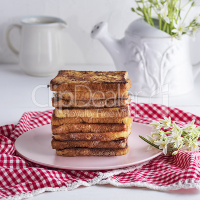 fried square pieces of white bread on a pink ceramic plate