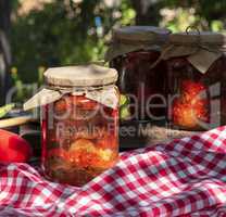 Canned eggplant slices in spicy vegetable sauce in glass jars