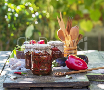 canned eggplant with vegetables on a brown wooden board