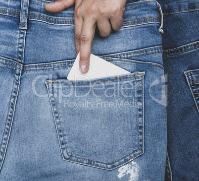hand sticks an empty paper business card into the back pocket