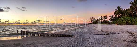 Dilapidated ruins of a pier on Port Royal Beach at sunset