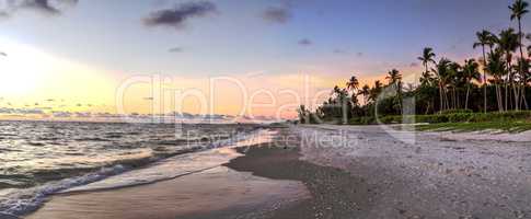 Dilapidated ruins of a pier on Port Royal Beach at sunset