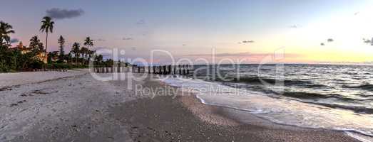 Dilapidated ruins of a pier on Port Royal Beach at sunset