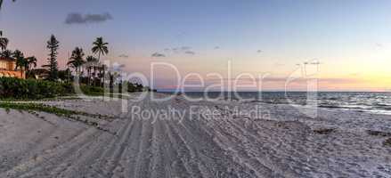 Dilapidated ruins of a pier on Port Royal Beach at sunset