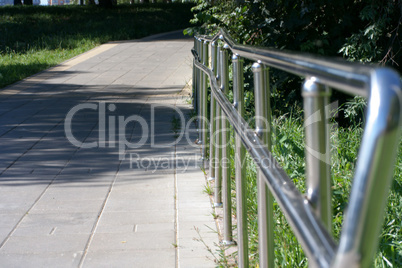 metal fence in park at dry sunny summer day