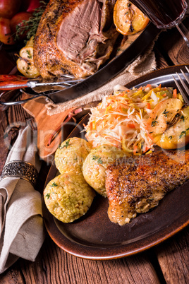 classic and crispy roasted duck with cabbage and dumplings