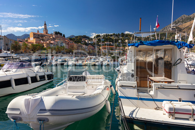 Boats in Menton harbor and the Basilique Saint-Michel, France, E