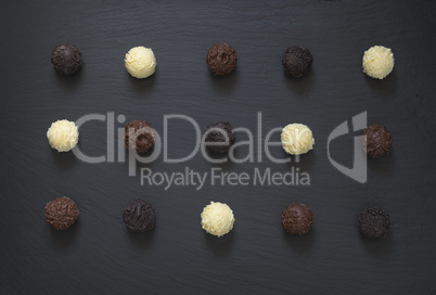 Fancy chocolate truffles ready to eat on black