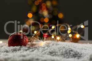 Christmas balls with an electric garland under the snow