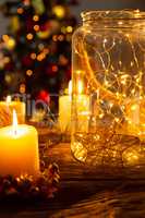 Christmas electric garland in a glass jar with candles