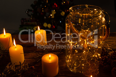 small electric garland in a glass jar with candles