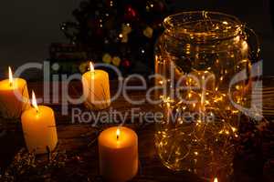 small electric garland in a glass jar with candles