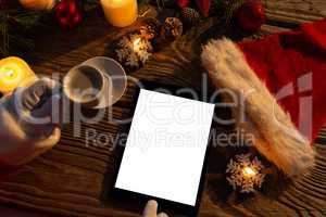 Santa Claus hands with coffee and tablet