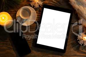 digital tablet and smartphone with Christmas ornament