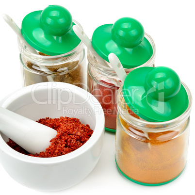 Set of spices and mortar with a pestle isolated on white backgro
