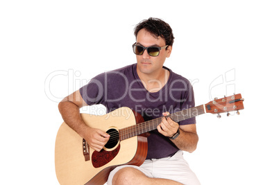 Close up image of man playing his guitar